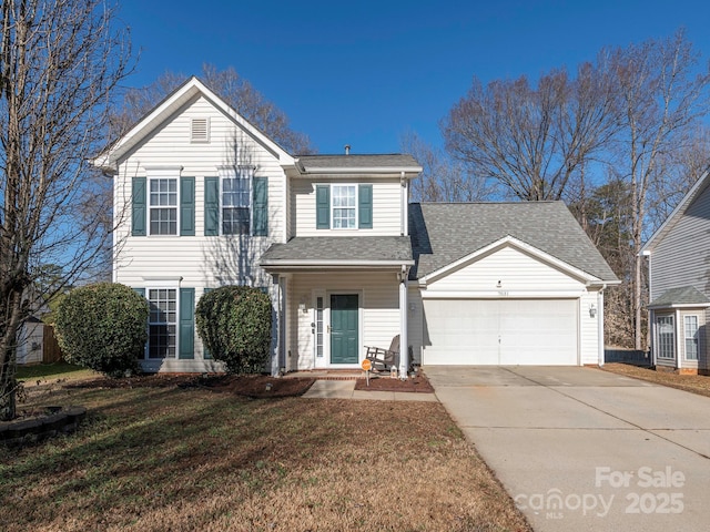 view of property with a garage and a front yard