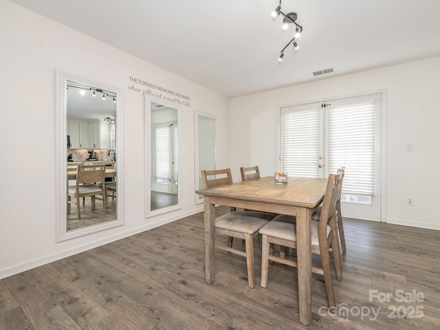 dining area with dark hardwood / wood-style floors