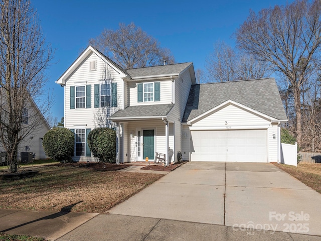 view of front property with a garage, a front lawn, and central air condition unit