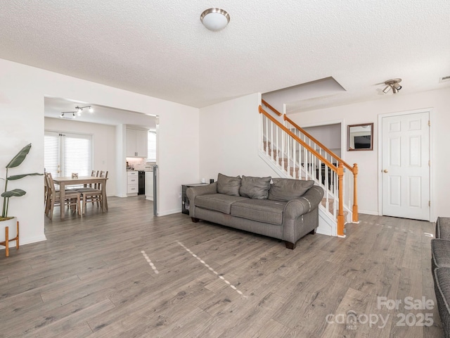 living room with hardwood / wood-style flooring and a textured ceiling