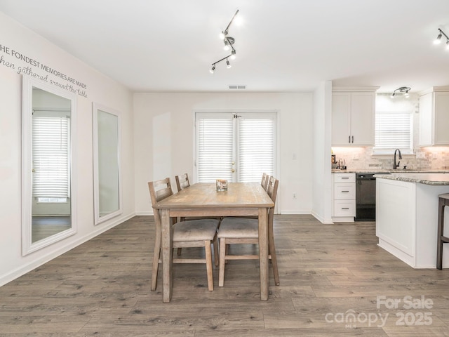 dining space featuring dark hardwood / wood-style floors and sink