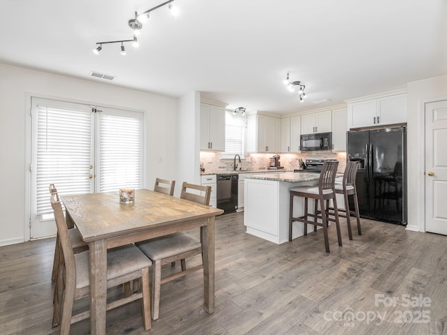 dining room featuring sink and hardwood / wood-style floors