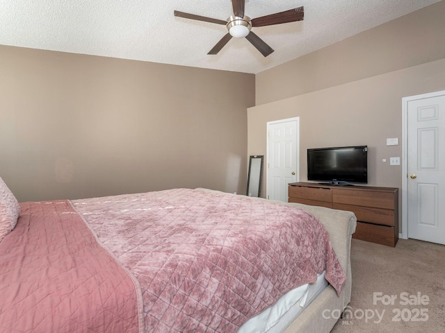 bedroom with ceiling fan, light colored carpet, vaulted ceiling, and a textured ceiling