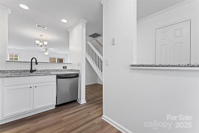 kitchen with white cabinetry, sink, stainless steel dishwasher, and light stone counters