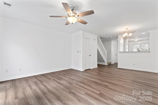 unfurnished living room with hardwood / wood-style flooring and ceiling fan with notable chandelier