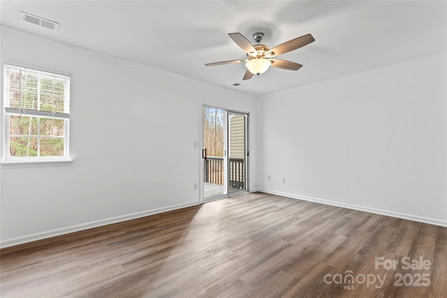 spare room featuring wood-type flooring and ceiling fan