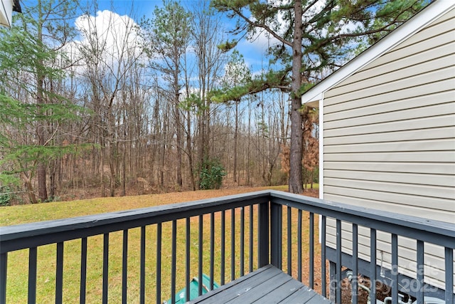 wooden deck featuring a lawn