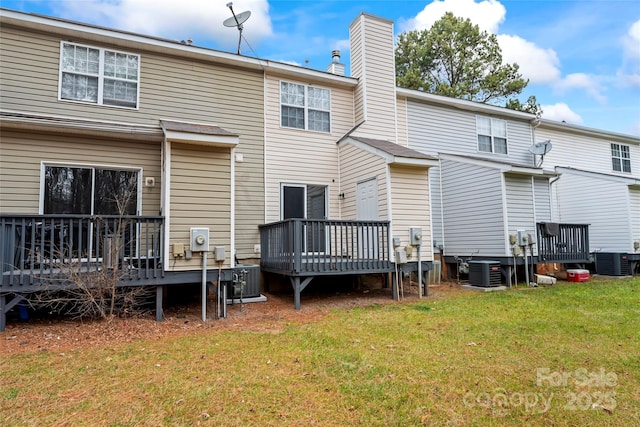 back of house with a wooden deck, a lawn, and central air condition unit