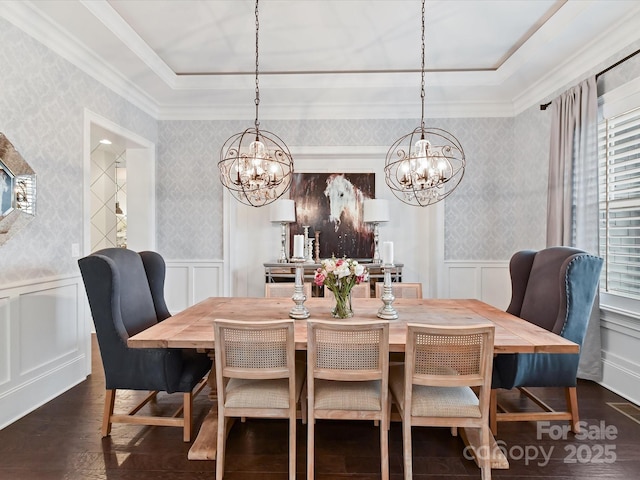 dining area featuring a raised ceiling, crown molding, an inviting chandelier, and dark hardwood / wood-style flooring