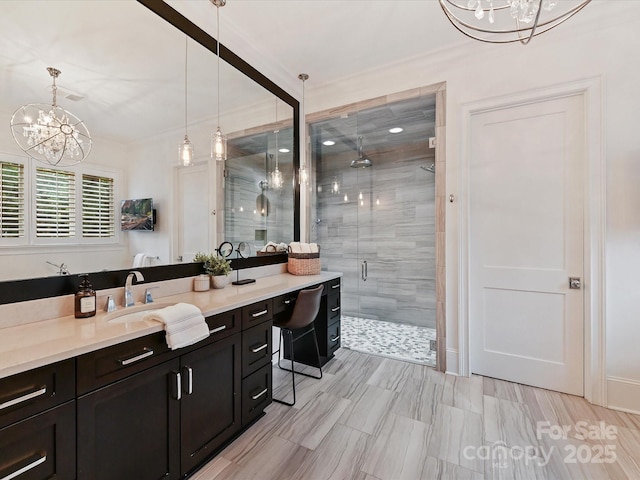 bathroom with an inviting chandelier, vanity, and an enclosed shower