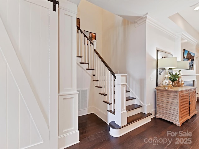 stairs featuring wood-type flooring and a barn door