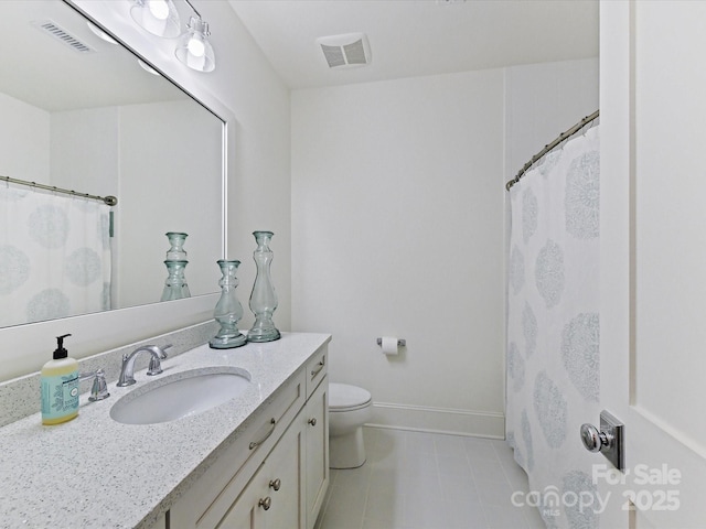 bathroom featuring vanity, toilet, and tile patterned flooring