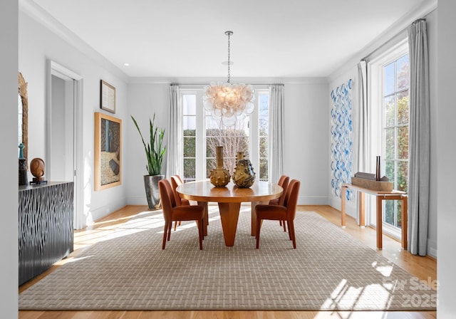 dining room featuring a healthy amount of sunlight and a chandelier