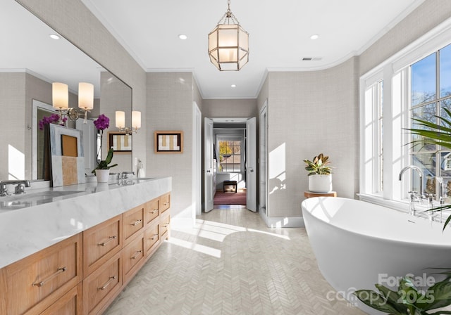 bathroom featuring ornamental molding, vanity, tile patterned floors, and a tub