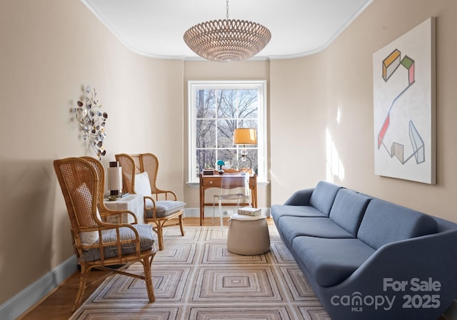 sitting room with crown molding and hardwood / wood-style floors