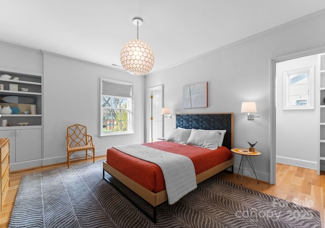 bedroom featuring wood-type flooring and ornamental molding