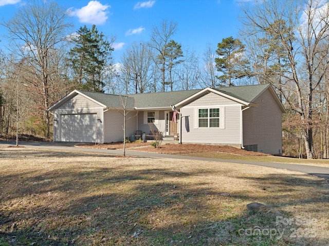 ranch-style home featuring a garage and a front lawn