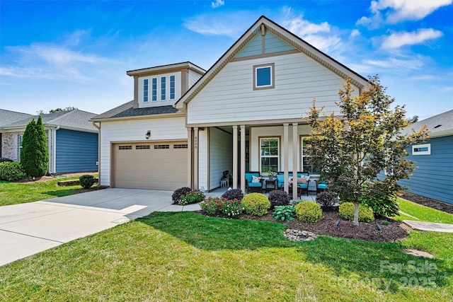 view of front of property featuring a garage, a porch, and a front yard