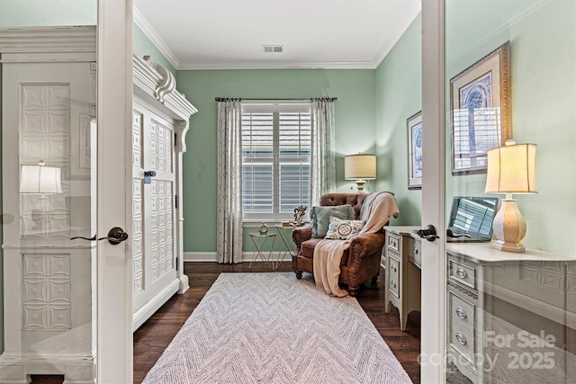 sitting room with crown molding and dark wood-type flooring