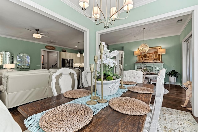 dining space with hardwood / wood-style floors, crown molding, and ceiling fan with notable chandelier