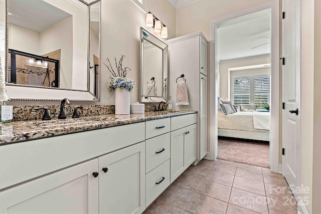 bathroom with a shower with door, ornamental molding, tile patterned floors, and vanity