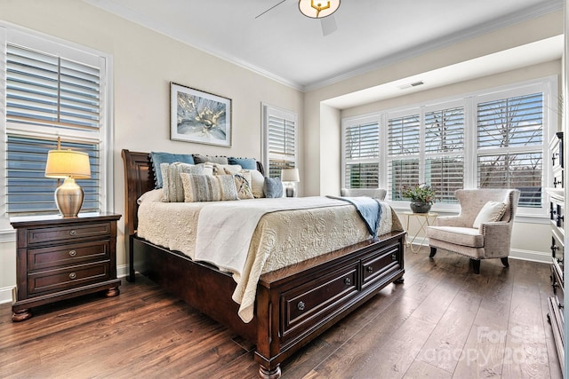 bedroom featuring dark wood-type flooring, ornamental molding, and ceiling fan