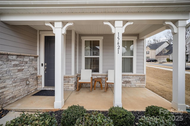 view of exterior entry with a porch