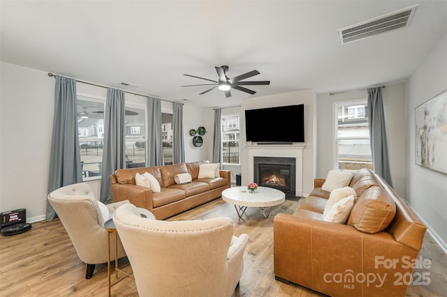 living room with ceiling fan and light hardwood / wood-style floors