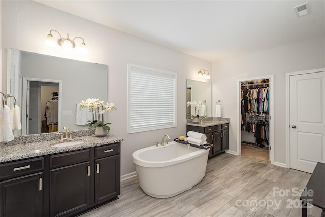 bathroom with vanity and a bathtub