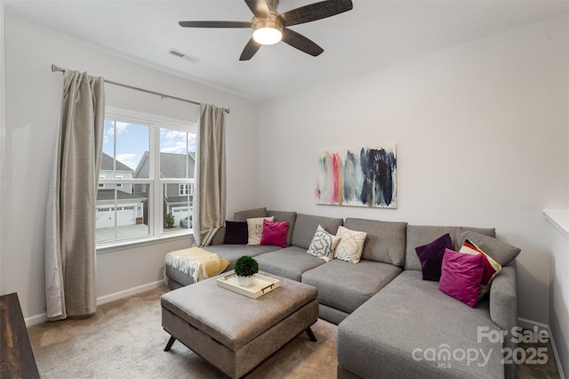 carpeted living room with ceiling fan