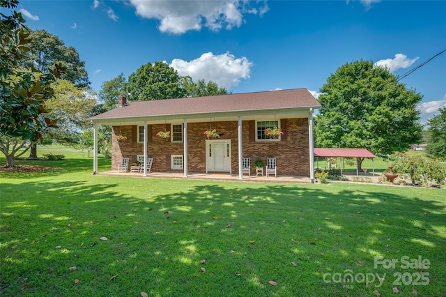 back of house featuring a yard and a patio