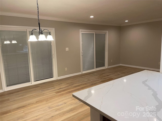 interior space featuring crown molding, baseboards, a chandelier, recessed lighting, and light wood-style flooring