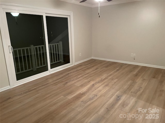 empty room with crown molding, hardwood / wood-style flooring, and ceiling fan