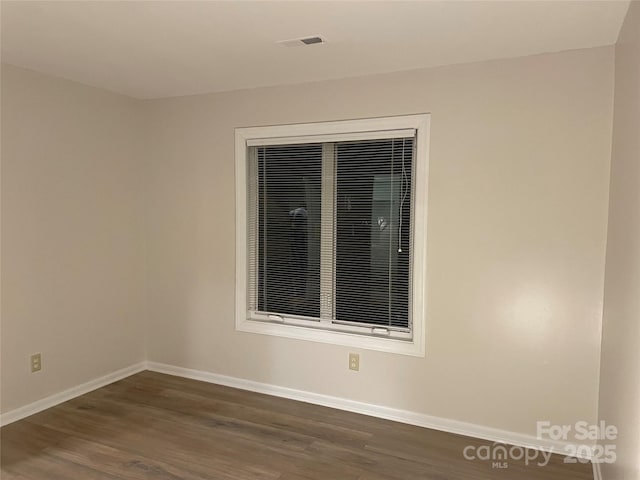 empty room with dark hardwood / wood-style floors