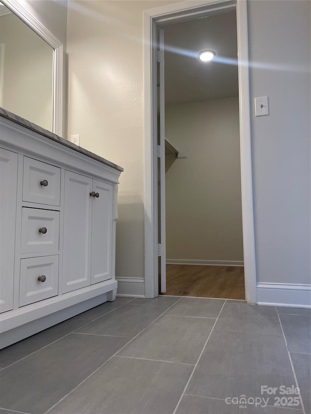 bathroom with tile patterned flooring and baseboards