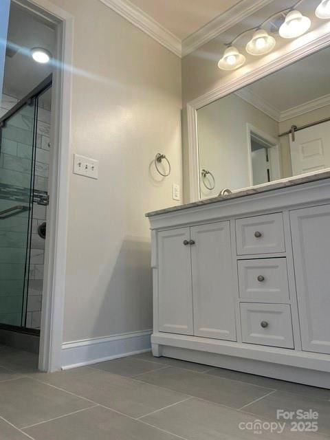 full bath featuring a shower stall, vanity, crown molding, and baseboards