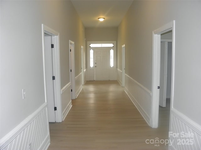 hallway with light hardwood / wood-style floors