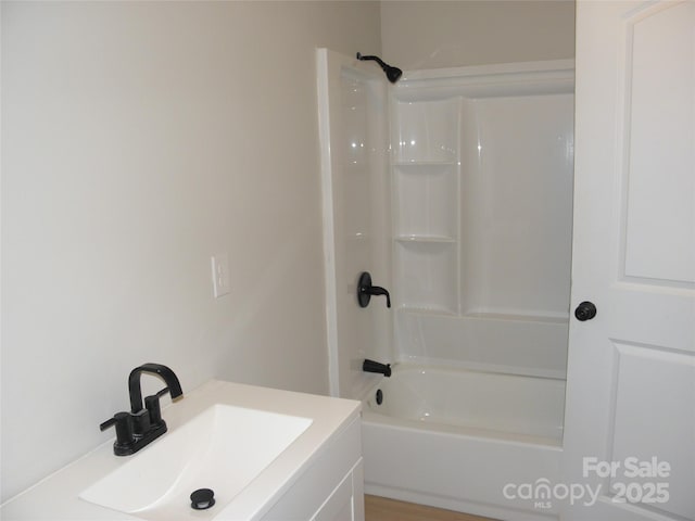 bathroom with tub / shower combination and sink