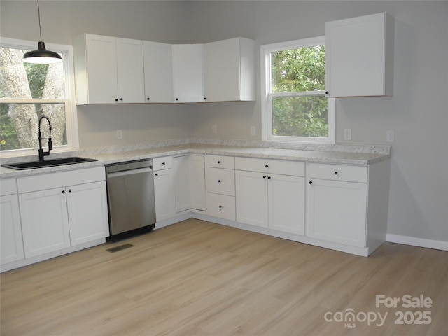 kitchen with white cabinetry, light hardwood / wood-style floors, dishwasher, and sink