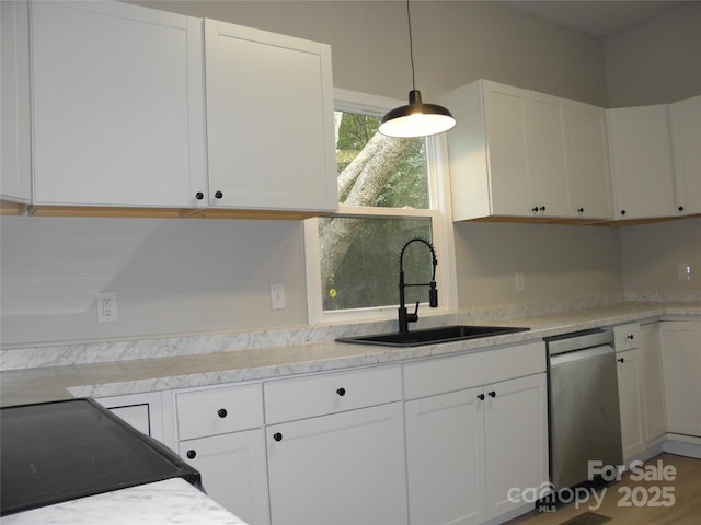 kitchen featuring range with electric cooktop, white cabinetry, dishwasher, sink, and hanging light fixtures