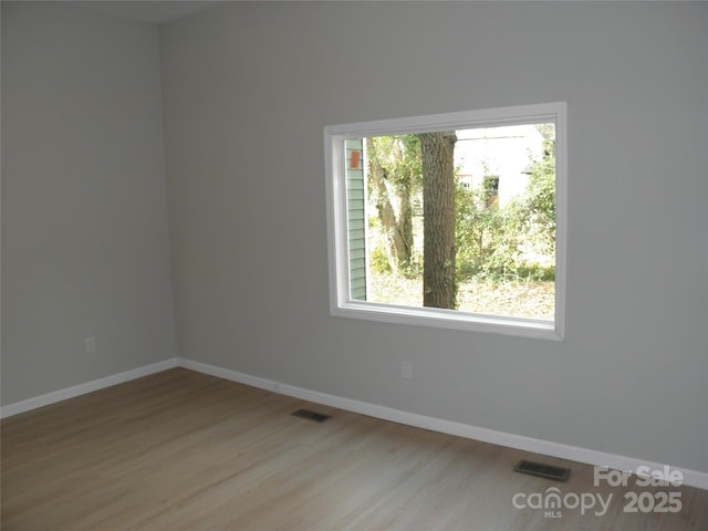 empty room with hardwood / wood-style flooring