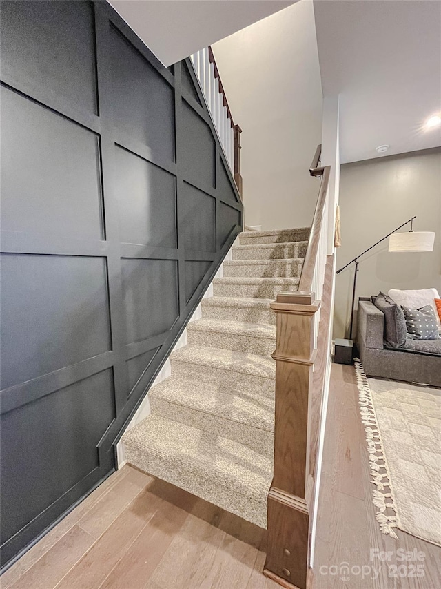 stairway with hardwood / wood-style floors