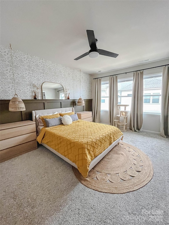 bedroom with multiple windows, ceiling fan, and carpet flooring