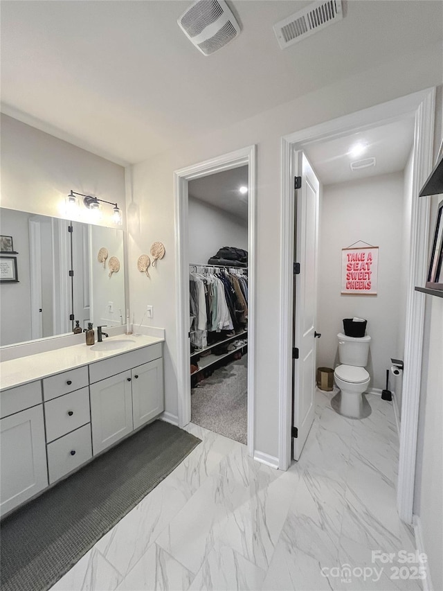 bathroom with vanity and toilet