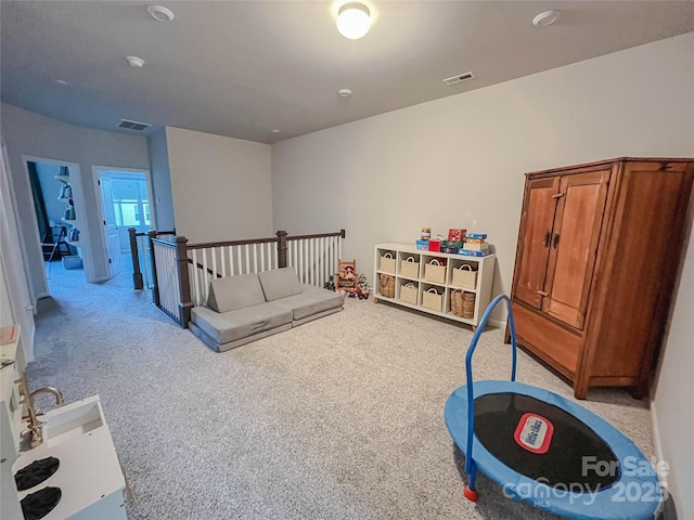 rec room with light colored carpet