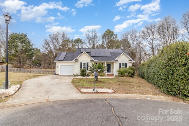 single story home featuring a garage, a front lawn, and solar panels