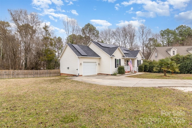 view of front of property featuring a garage and a front lawn