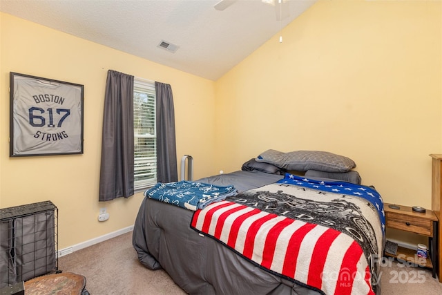 bedroom featuring lofted ceiling, carpet floors, a textured ceiling, and ceiling fan