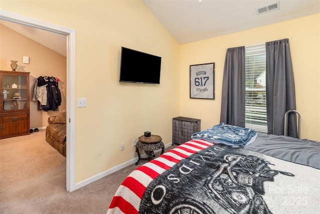 bedroom with lofted ceiling and light carpet