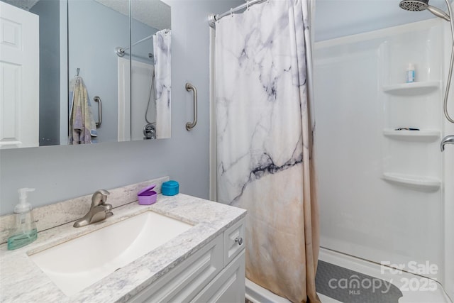 bathroom featuring vanity, a textured ceiling, and a shower with shower curtain